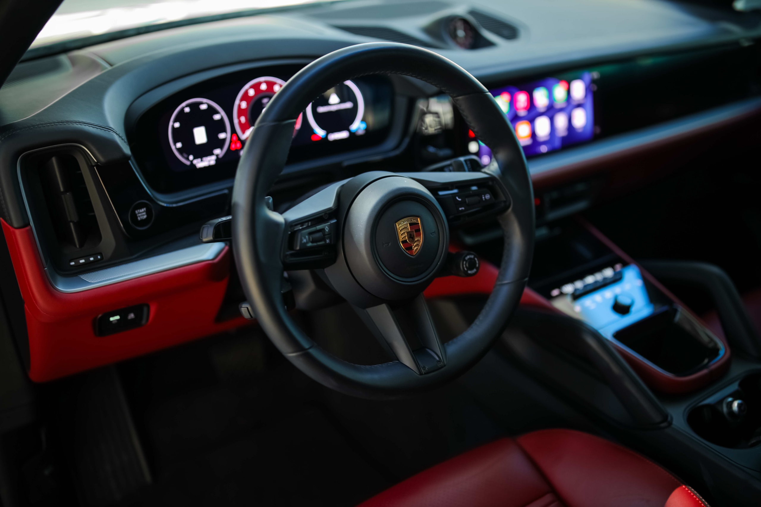 Porsche Cayenne steering wheel, digital instruments, and Apple CarPlay screen