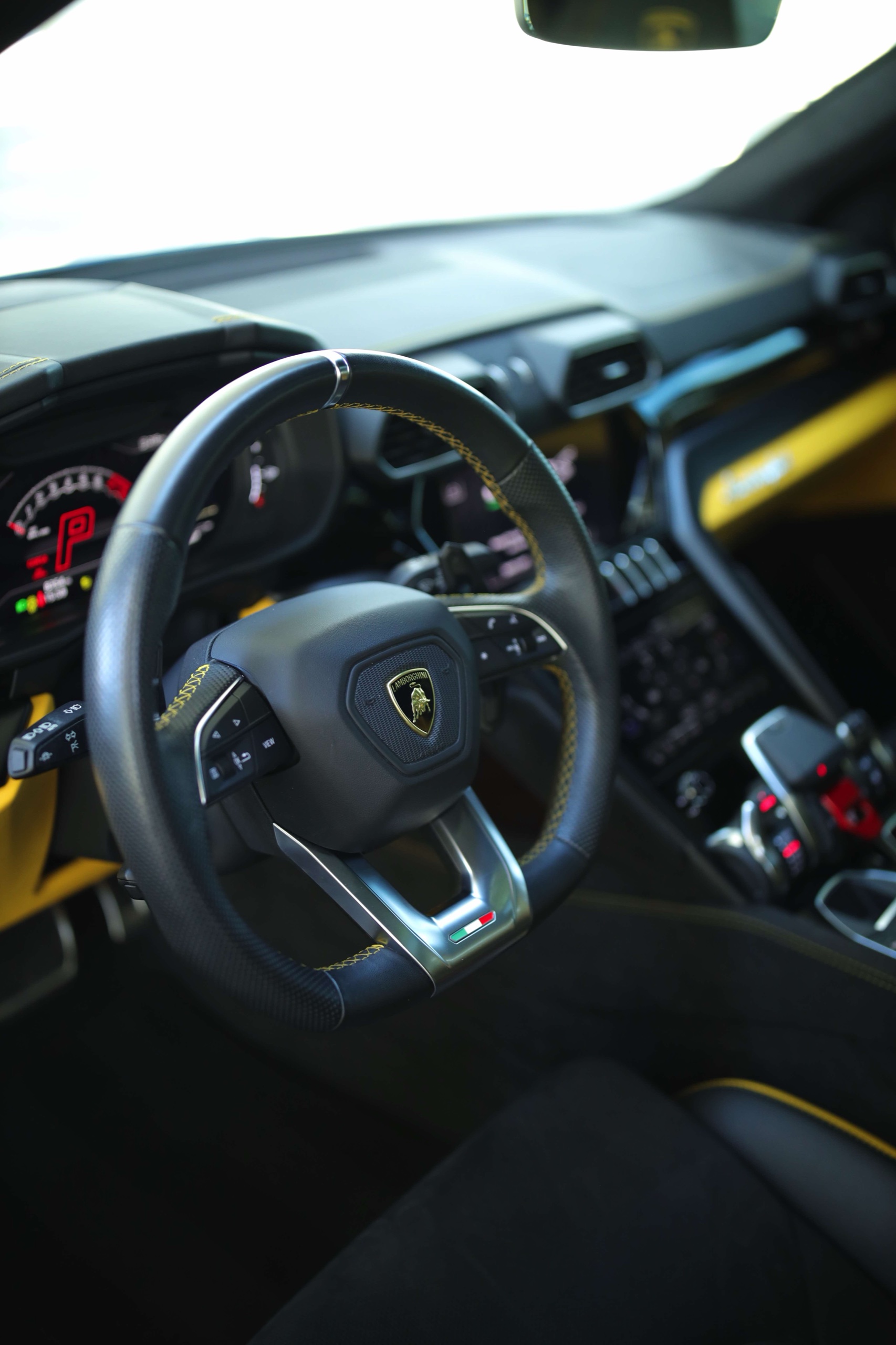 Lamborghini Urus S steering wheel, instruments and yellow dashboard trim