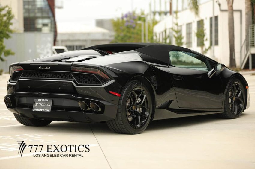 rear corner view of black huracan spyder