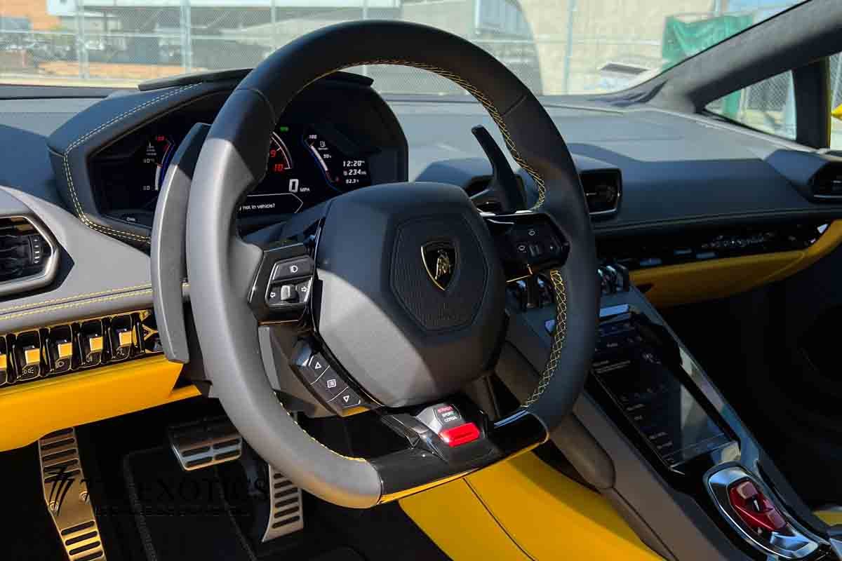 steering wheel of the yellow lamborghini huracan